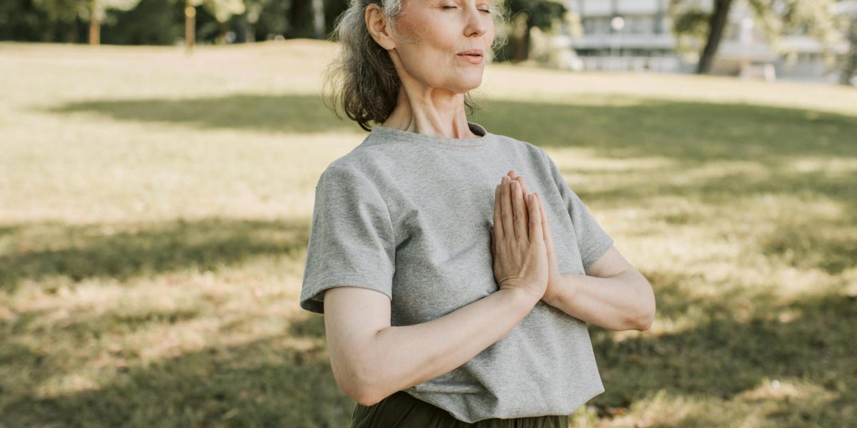 A person in a tranquil setting, demonstrating the calm achieved through meditation.