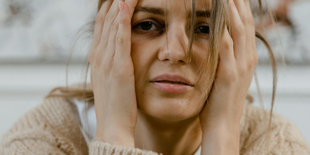 A person looks concerned while checking their health, reflecting common anxiety about blood pressure readings.