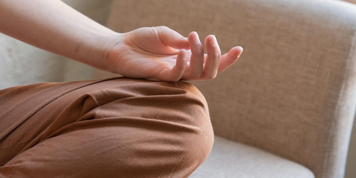 A person in a serene setting, eyes closed, experiencing the calming effects of meditation.