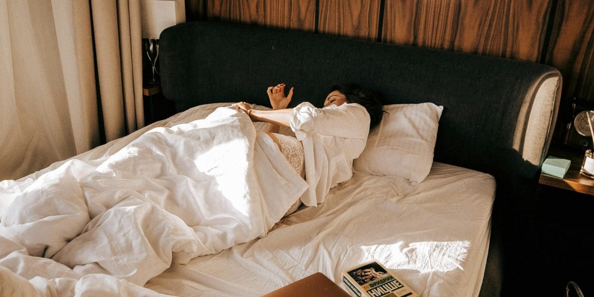 A dim, cool, and quiet bedroom optimized for restful sleep, emphasizing environment's importance.