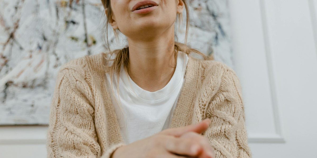 A person experiencing a moment of breathlessness, conveying the common sensation of anxiety-induced breathing trouble.
