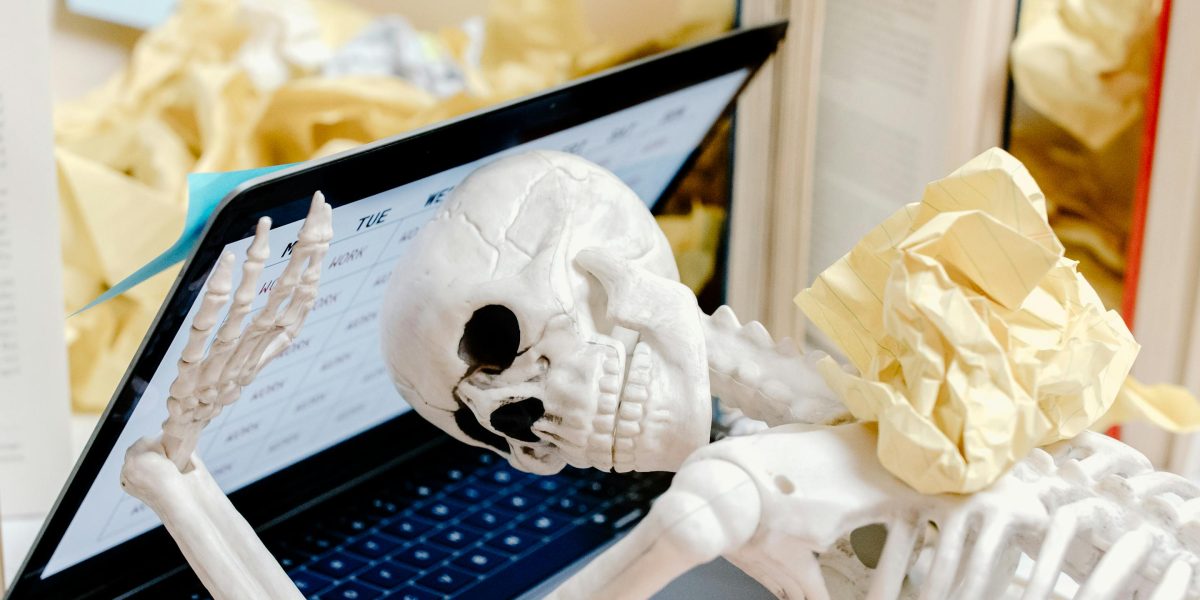 A person feeling overwhelmed by daily stressors, illustrating how the body's alarm system reacts to perceived threats.