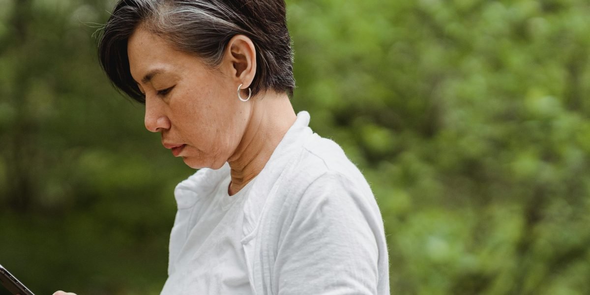 An individual using a mobile phone to access a breathwork app, demonstrating a moment of calm and focus.