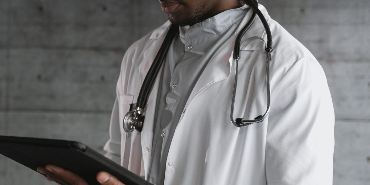 A person engages with a digital device, reflecting the act of analyzing personal health data and trends.