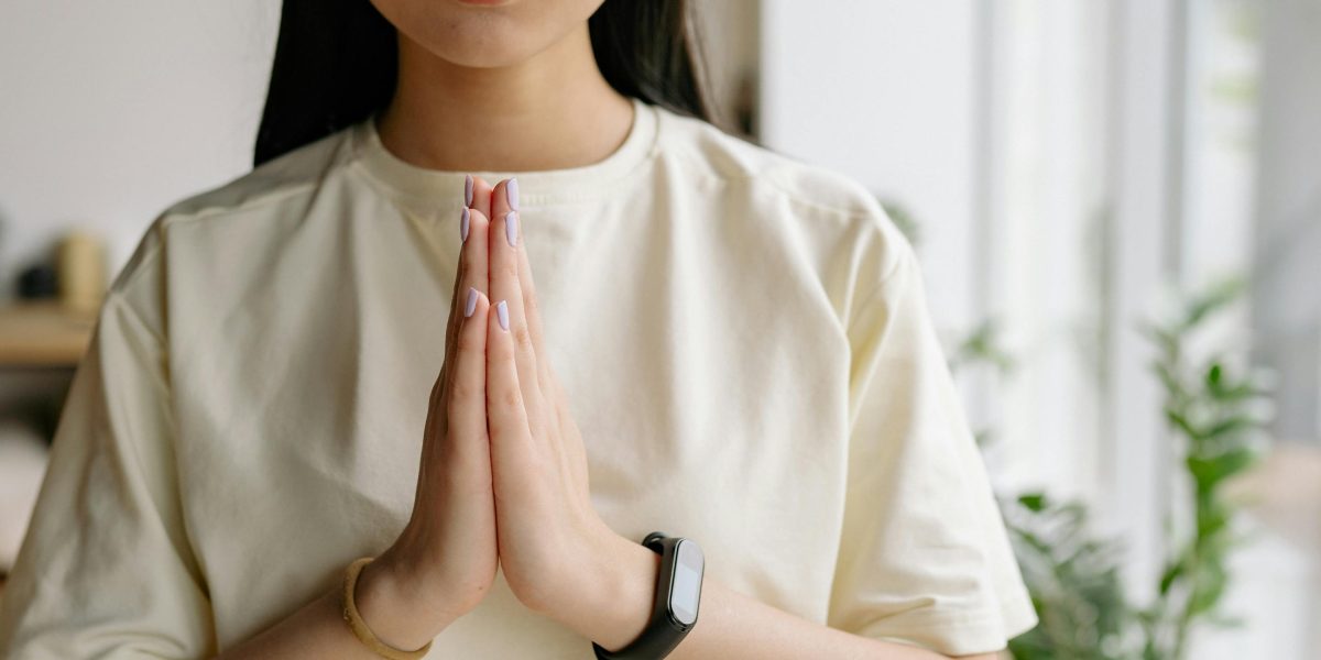 A person focuses on deep breathing, demonstrating a technique to calm the nervous system and manage anxiety.