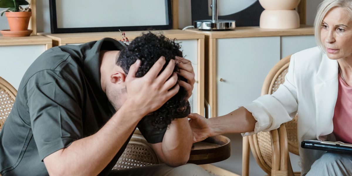 A person engaging in a therapy session with a professional, symbolizing seeking help for anxiety and alcohol issues.