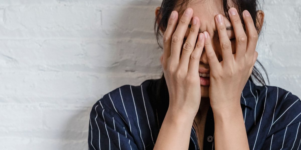 A person appearing stressed or overwhelmed, reflecting the common experience of anxiety in daily life.
