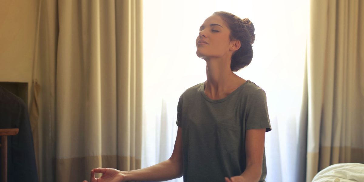 A person engaged in a calming breathing exercise, demonstrating a technique for relaxation and stress reduction.