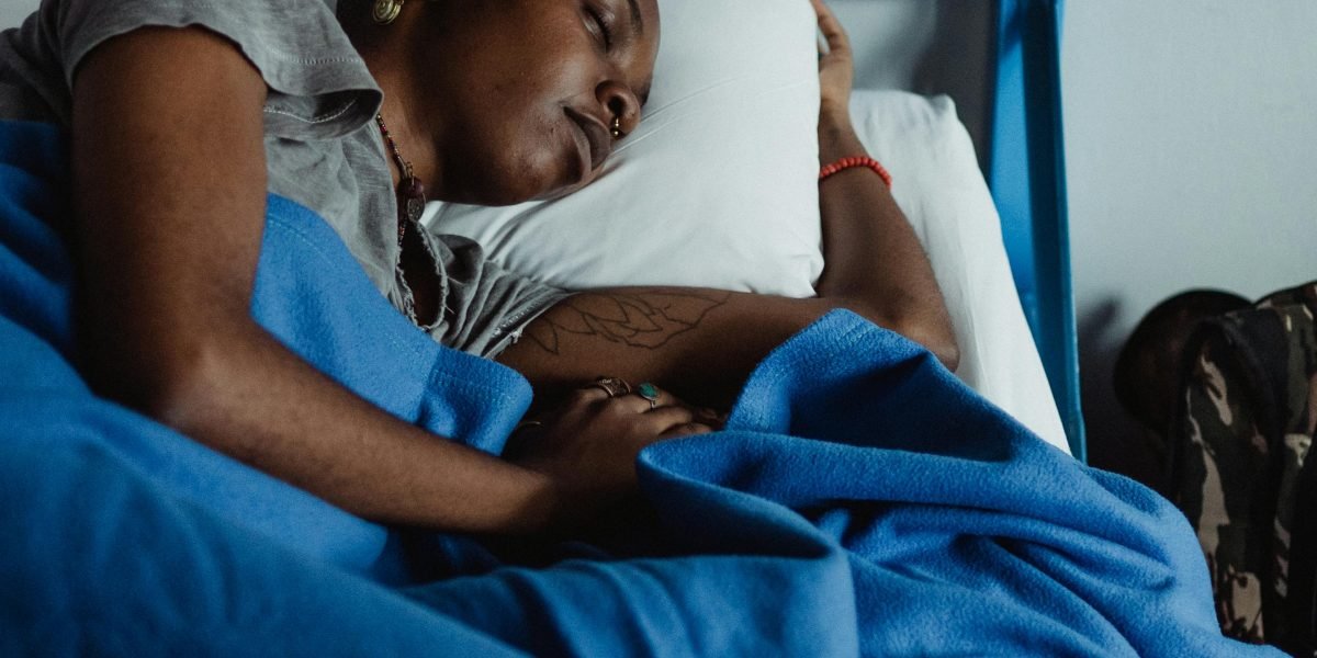A person resting peacefully in bed, embodying the goal of achieving deep, refreshing sleep.
