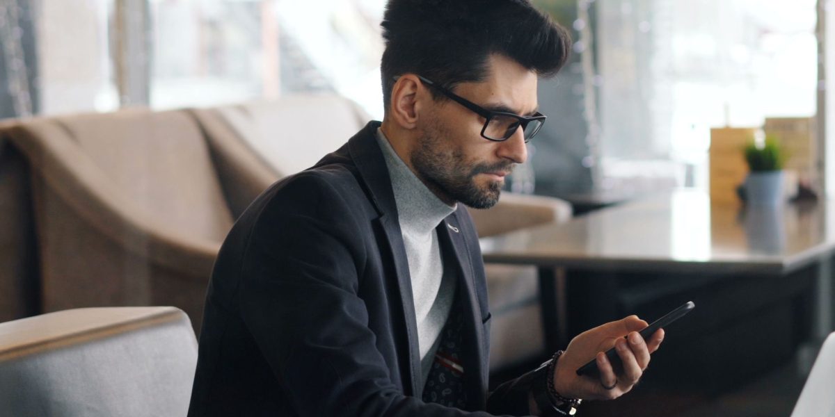 An individual subtly using calming techniques in a public or professional setting to manage anxiety.