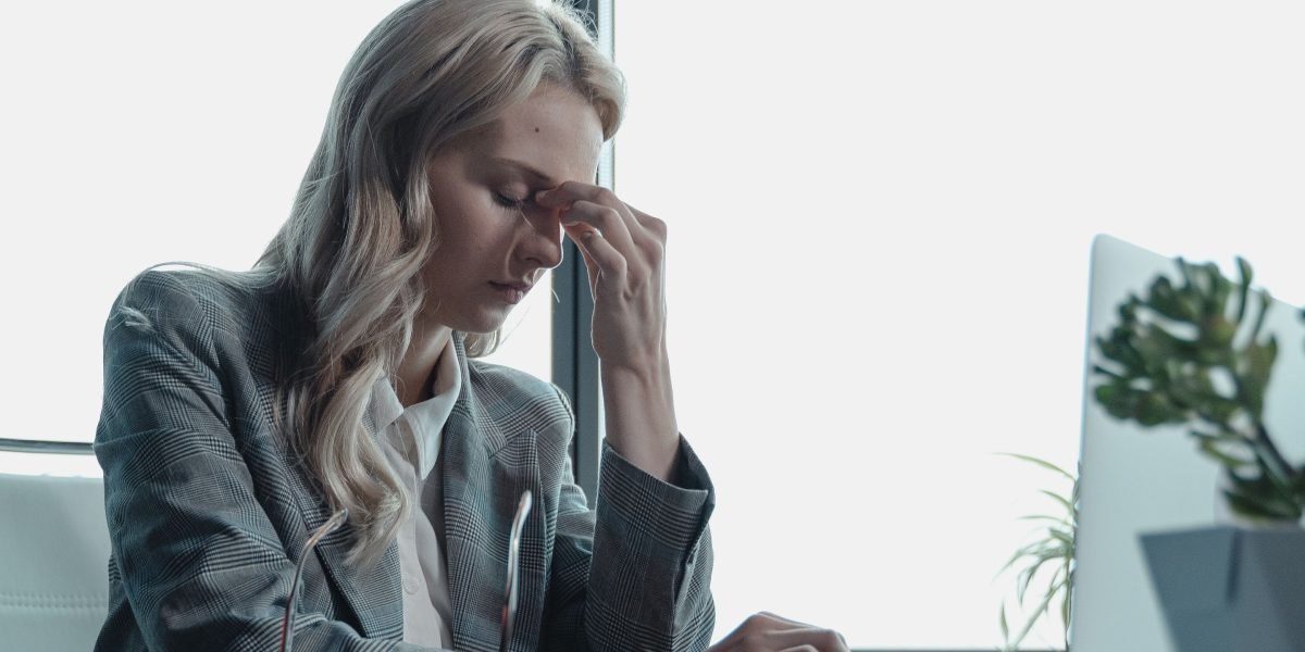 A professional takes a moment to recenter and manage stress during a busy workday.