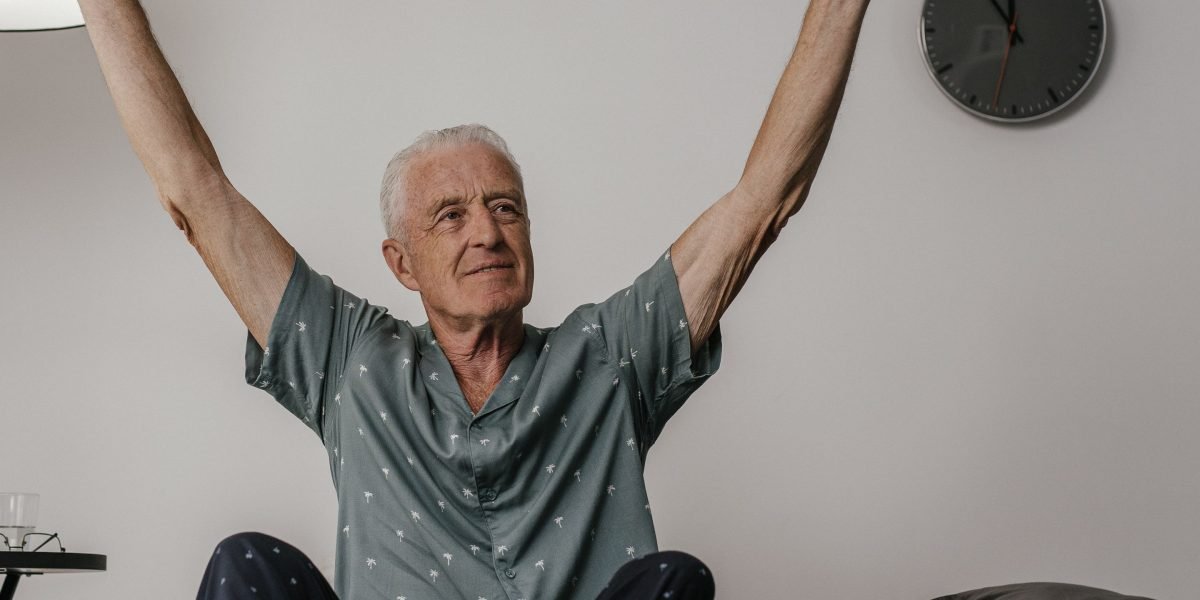 A person waking up feeling completely refreshed, showcasing the positive outcome of effective sleep practices.