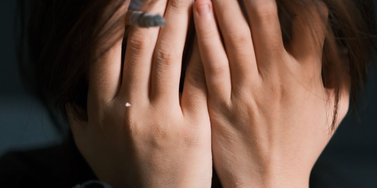 A person experiencing visible signs of stress, reflecting the physiological impact of anxiety on the body.