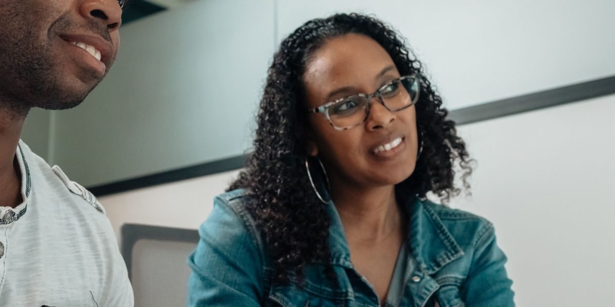 A person actively listening to another, demonstrating non-judgmental support.