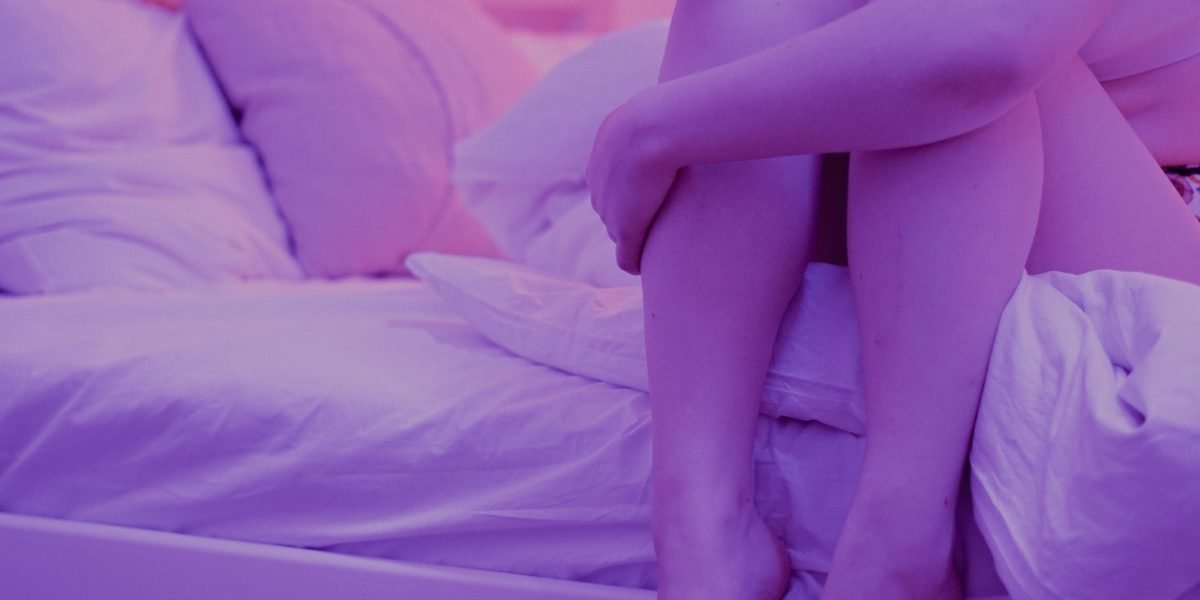 A person lying awake in bed, experiencing restlessness and racing thoughts commonly associated with anxiety.