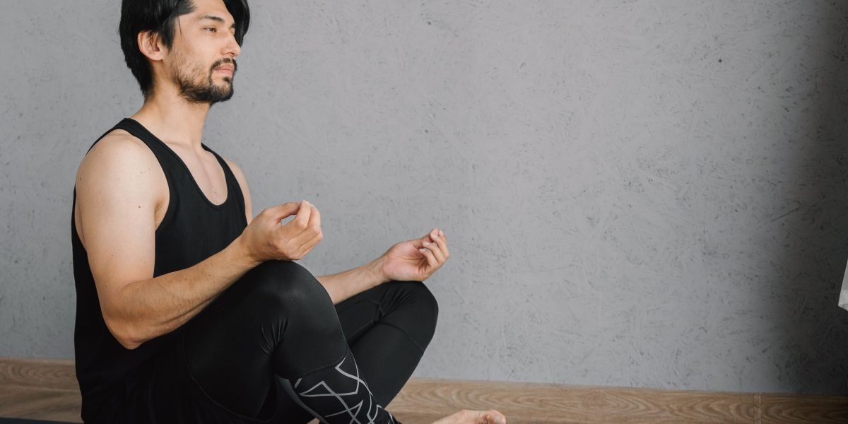 A person calmly practicing deep breathing techniques in a serene indoor setting.