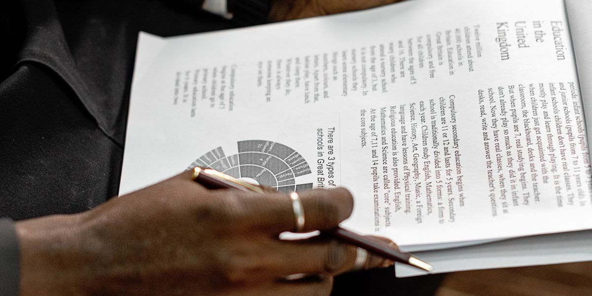 A professional reviewing documents, representing the process of discussing insurance, costs, and eligibility for mental health services.