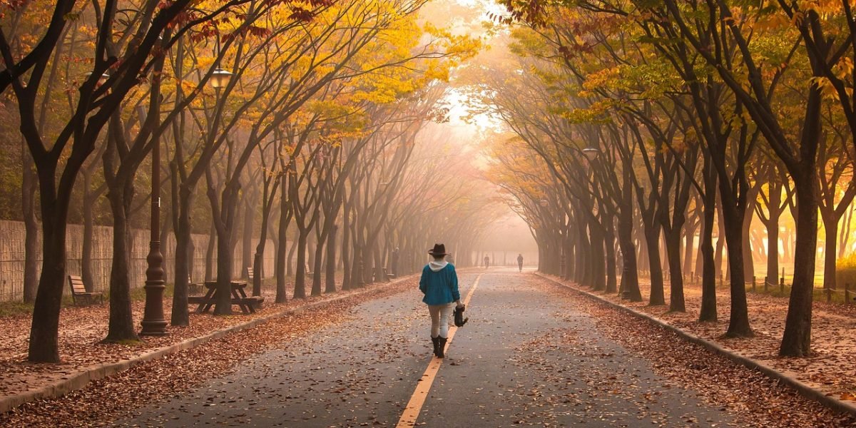 A person engaging in a mindful walking break, focusing on sensory details as a grounding exercise.