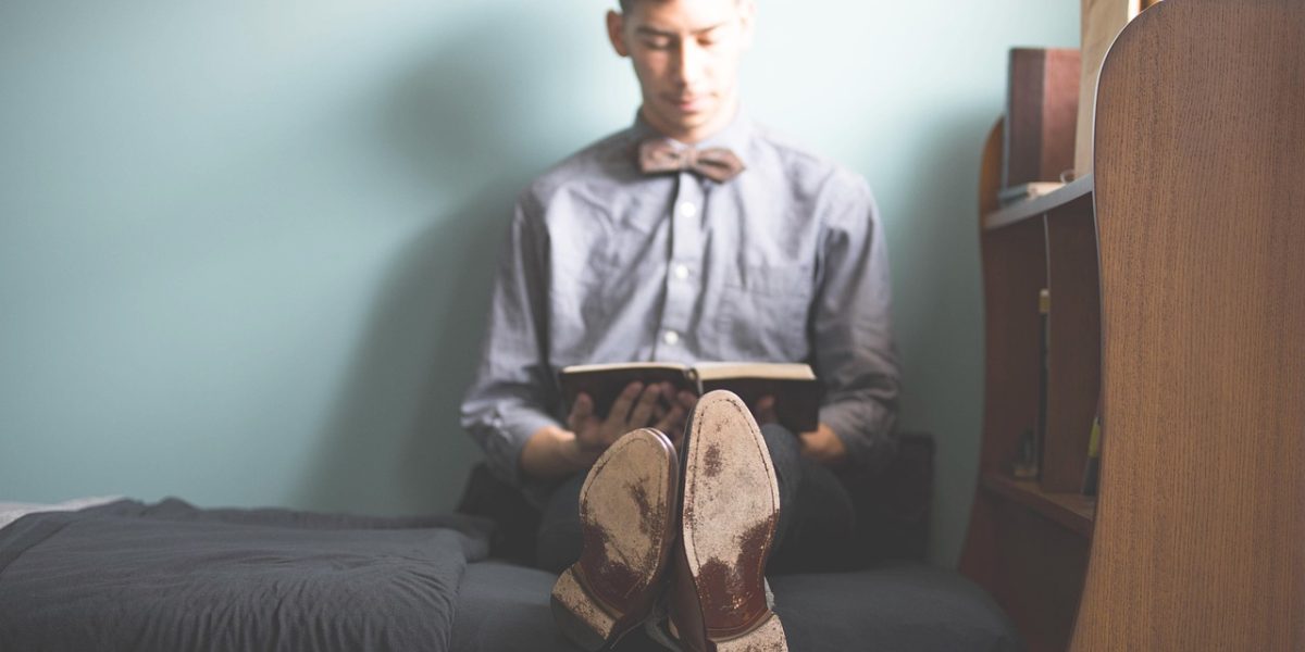 A person preparing their bedroom, ensuring a calm and inviting space for restful sleep.